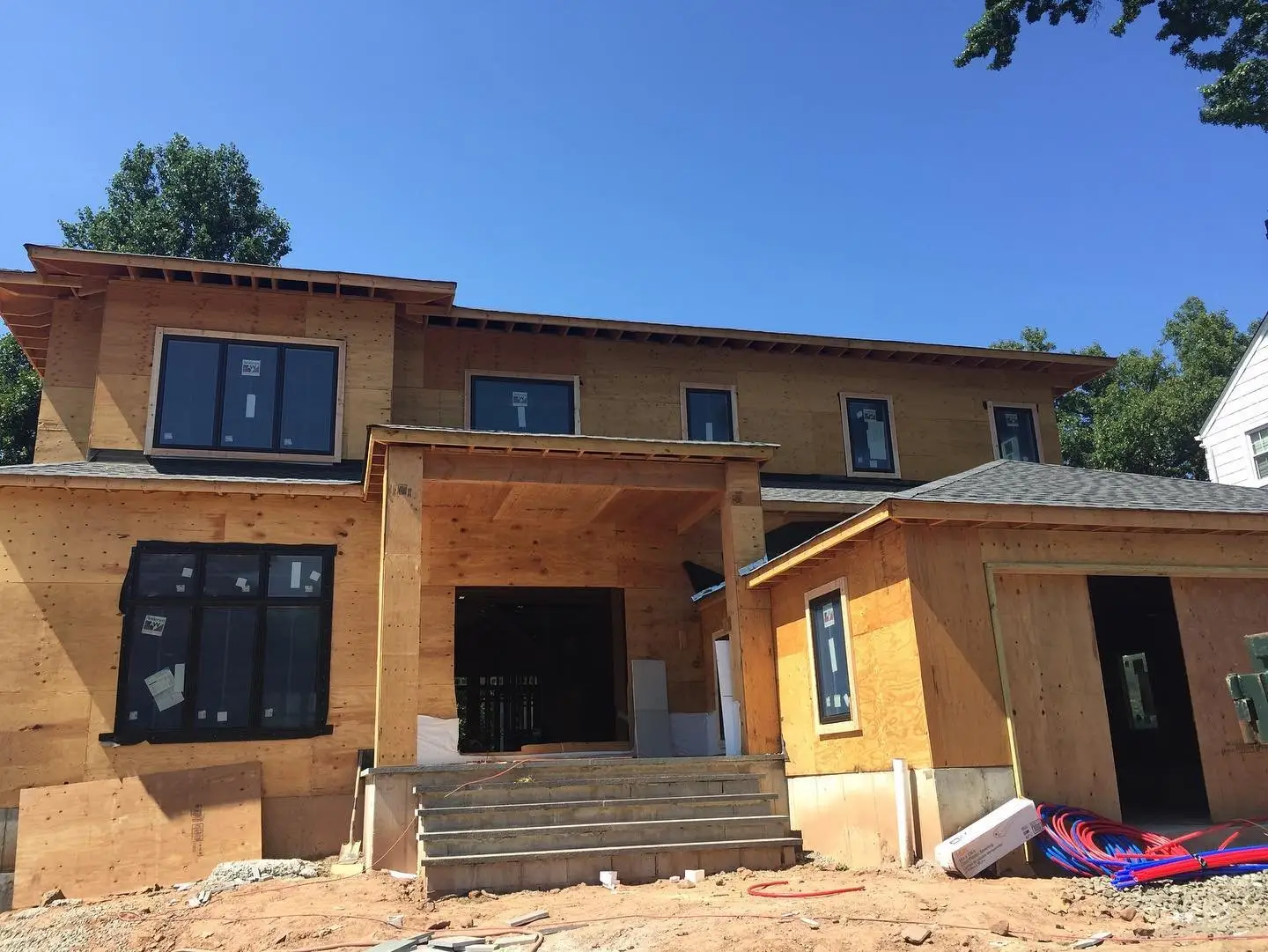 Framed new home with a covered front entry under construction in New Jersey