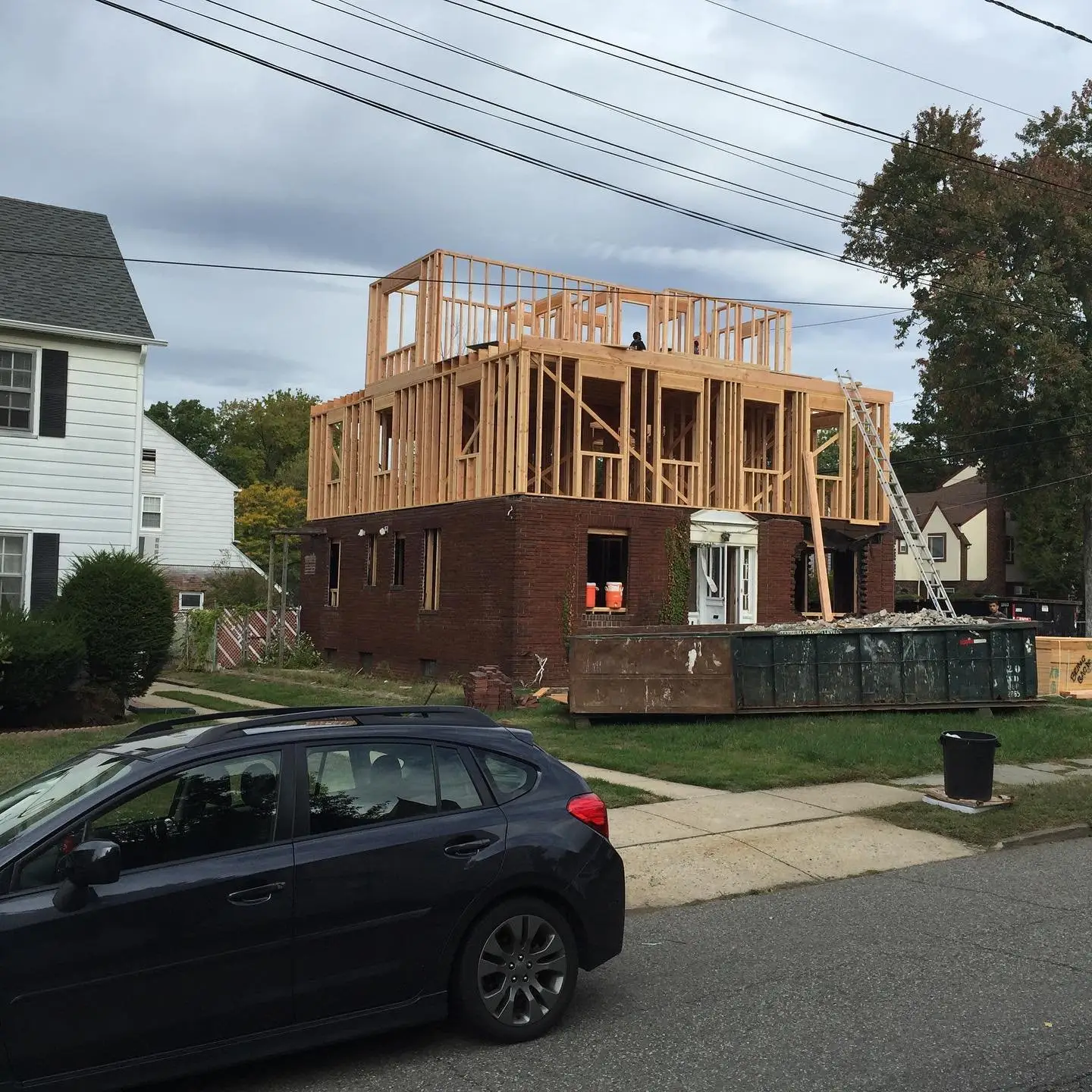 Second-story addition being framed over a brick first floor in New Jersey